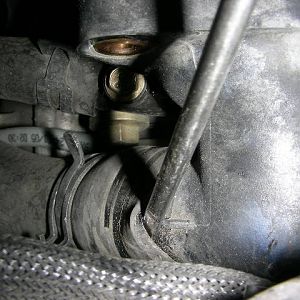 Screwdriver Loosening Coolant Hose