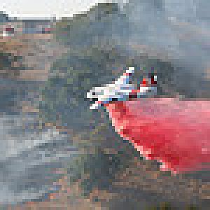 Fresno, CA based Tanker 78 making an air drop on a vegetation fire in Eastern Fresno County.

See my gallery for a photo with this aircraft.