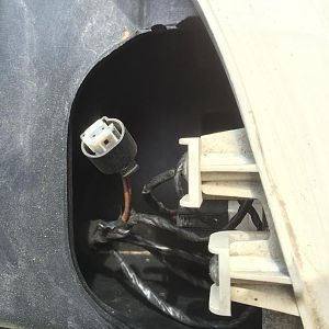 Under the left front headlight. What is that orphan connector?